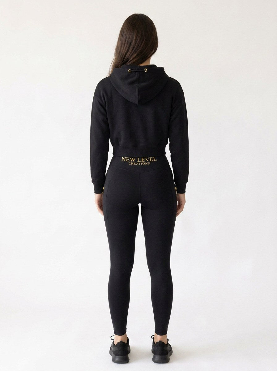 Paige crop zip hoodie in jet black worn with matching leggings, back view